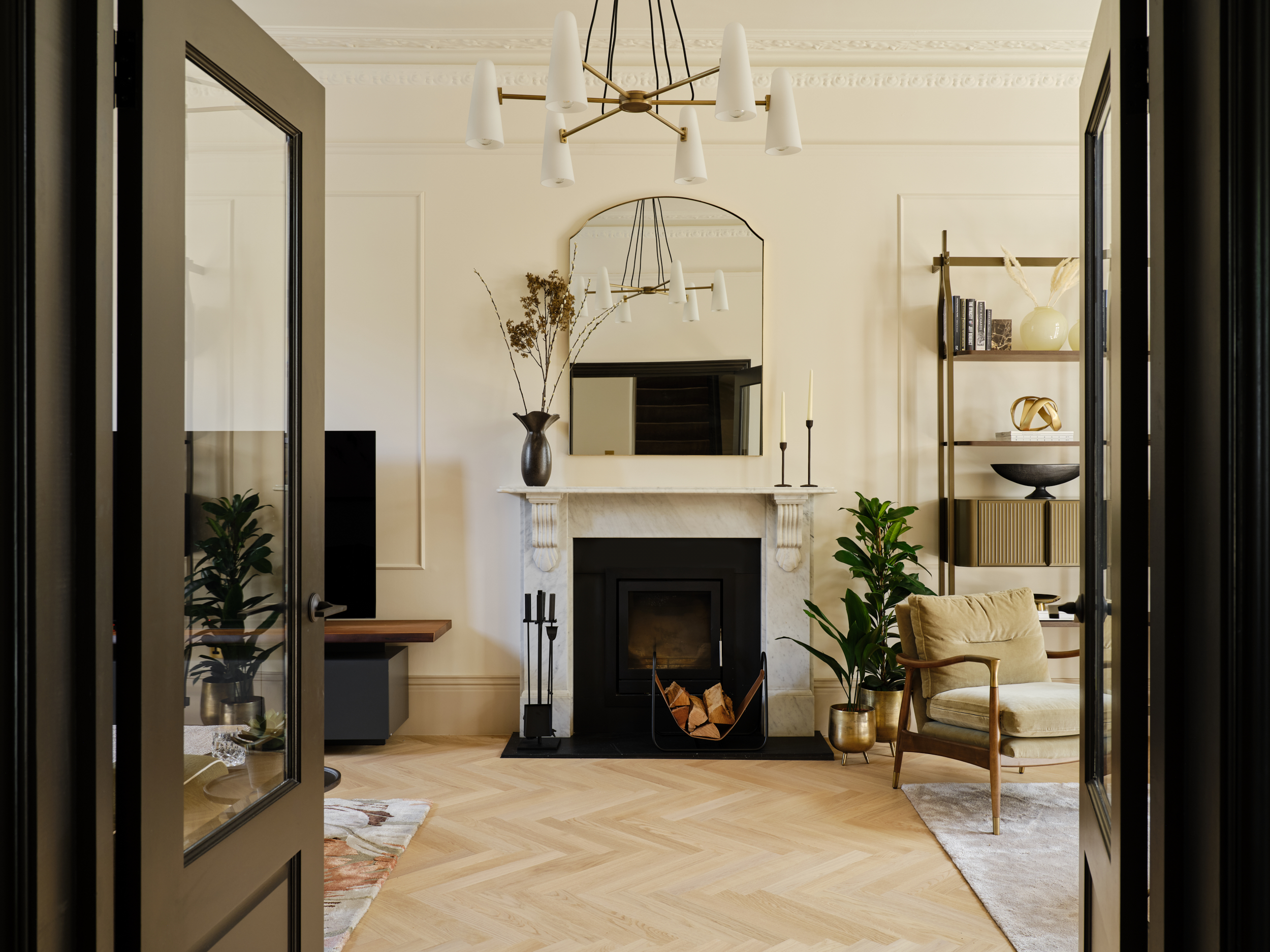 Layered lighting design in a period double living room with chandelier, mirror above fireplace, and bespoke joinery, from Studio 3 Creatives' Heart of Putney II project