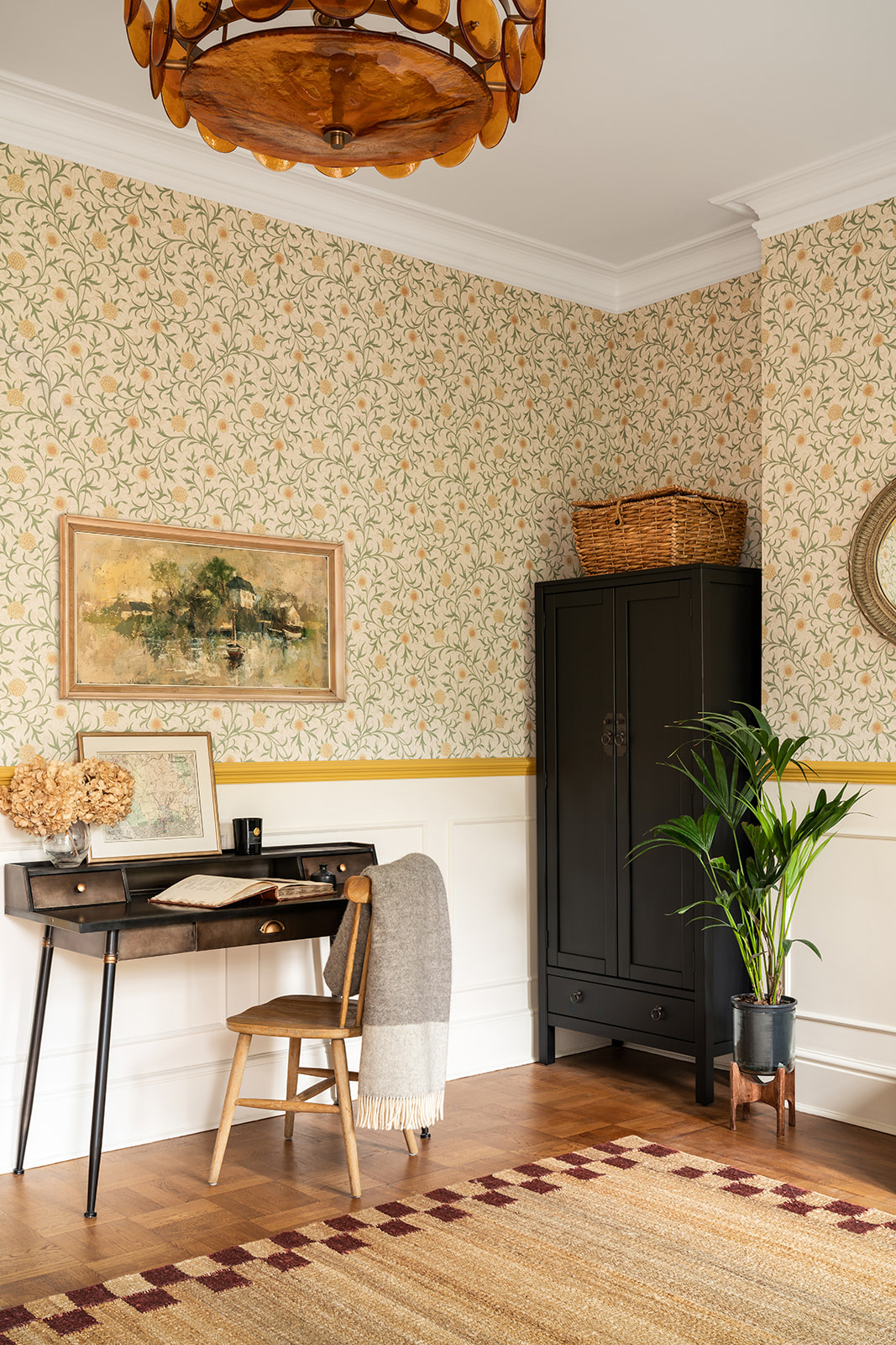 Sustainable entrance hall in a London period property with vintage desk, patterned wallpaper, and eco-friendly finishes.
