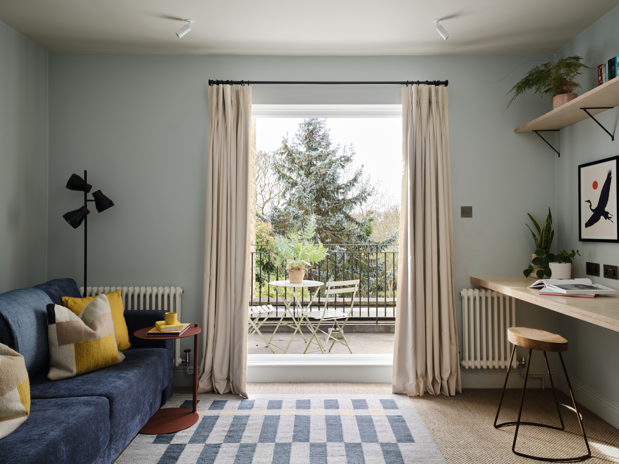 Dual-purpose study and guest room with navy sofa, bespoke