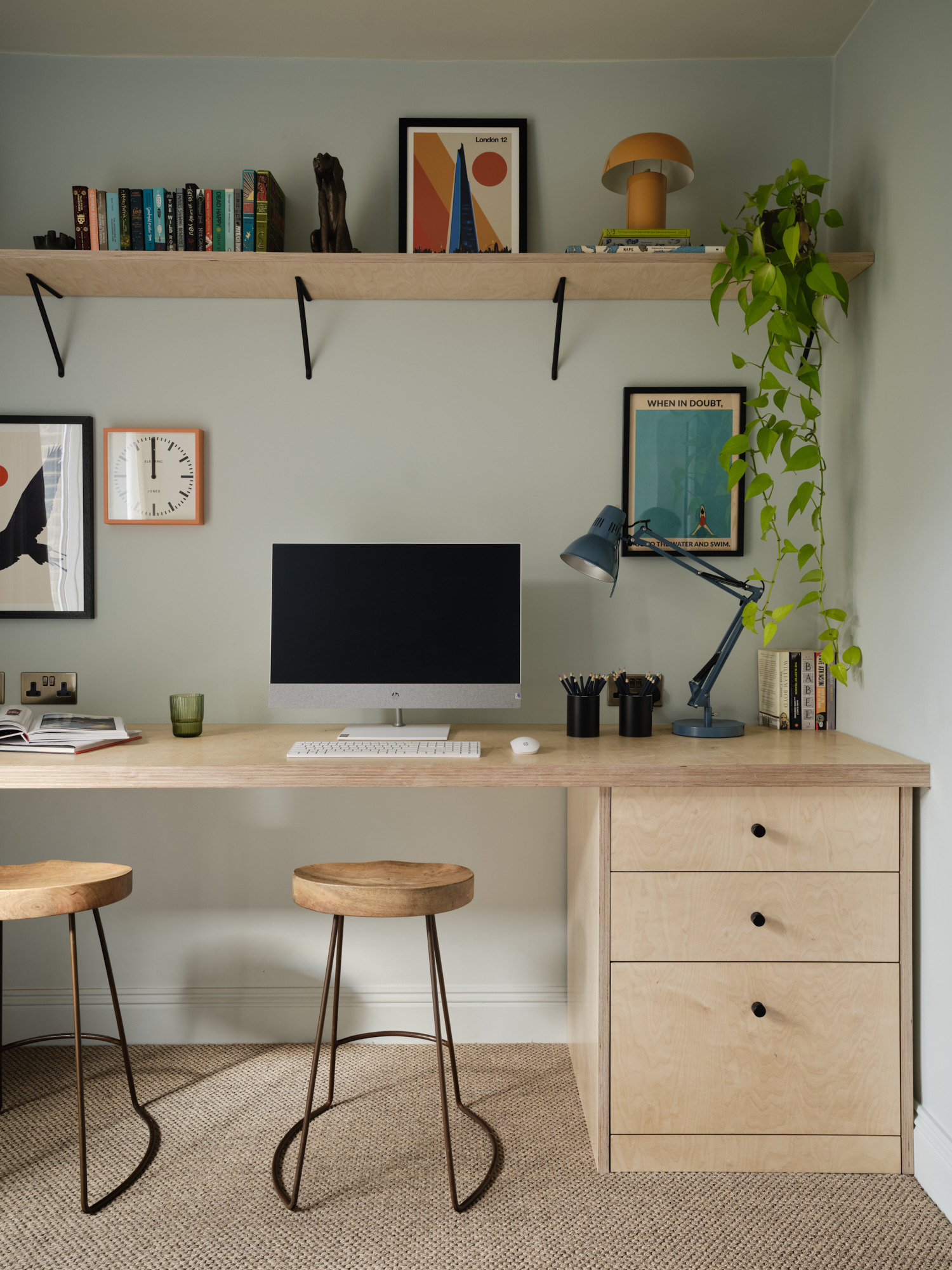 Full-width bespoke plywood study desk for two with monitor and wall shelving above, interior design St Margarets London