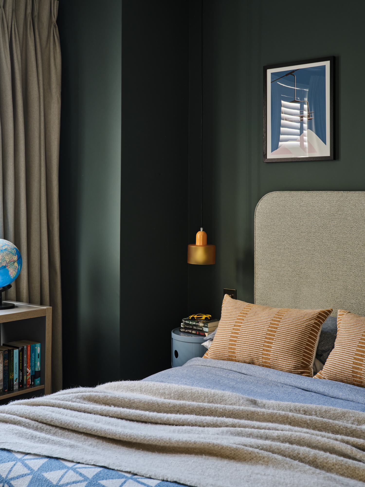Forest green teenage bedroom wide view with linen curtains, globe on bookshelf and amber pendant light, St Margarets London interior design