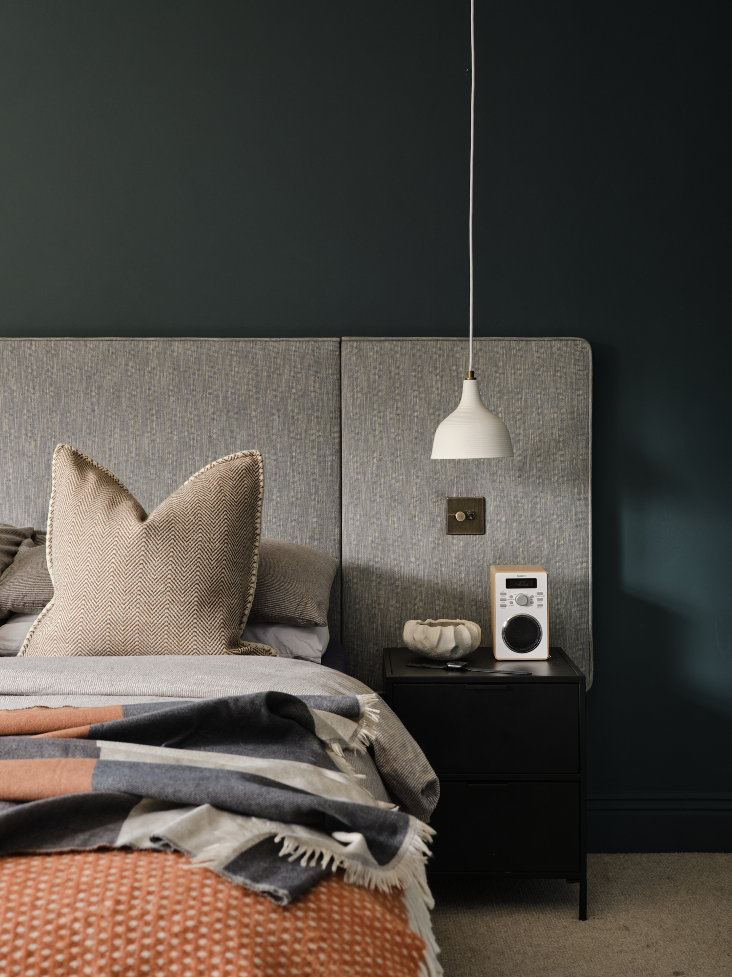 Dark teal teenage bedroom bedside with white pendant light and black bedside table with radio, interior design St Margarets London